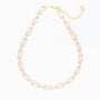 Gold necklace with rhinestone details on a white background