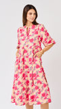 Woman wearing a  pink floral midi dress on a white background