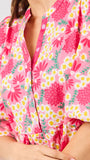 Woman wearing a  pink floral midi dress on a white background