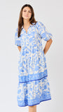 Woman wearing a blue floral dress on a white background