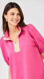 Woman wearing a pink dress with a white background