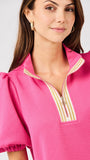 Woman wearing a pink top with a white background