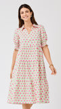 Woman wearing a patterned dress on a white background