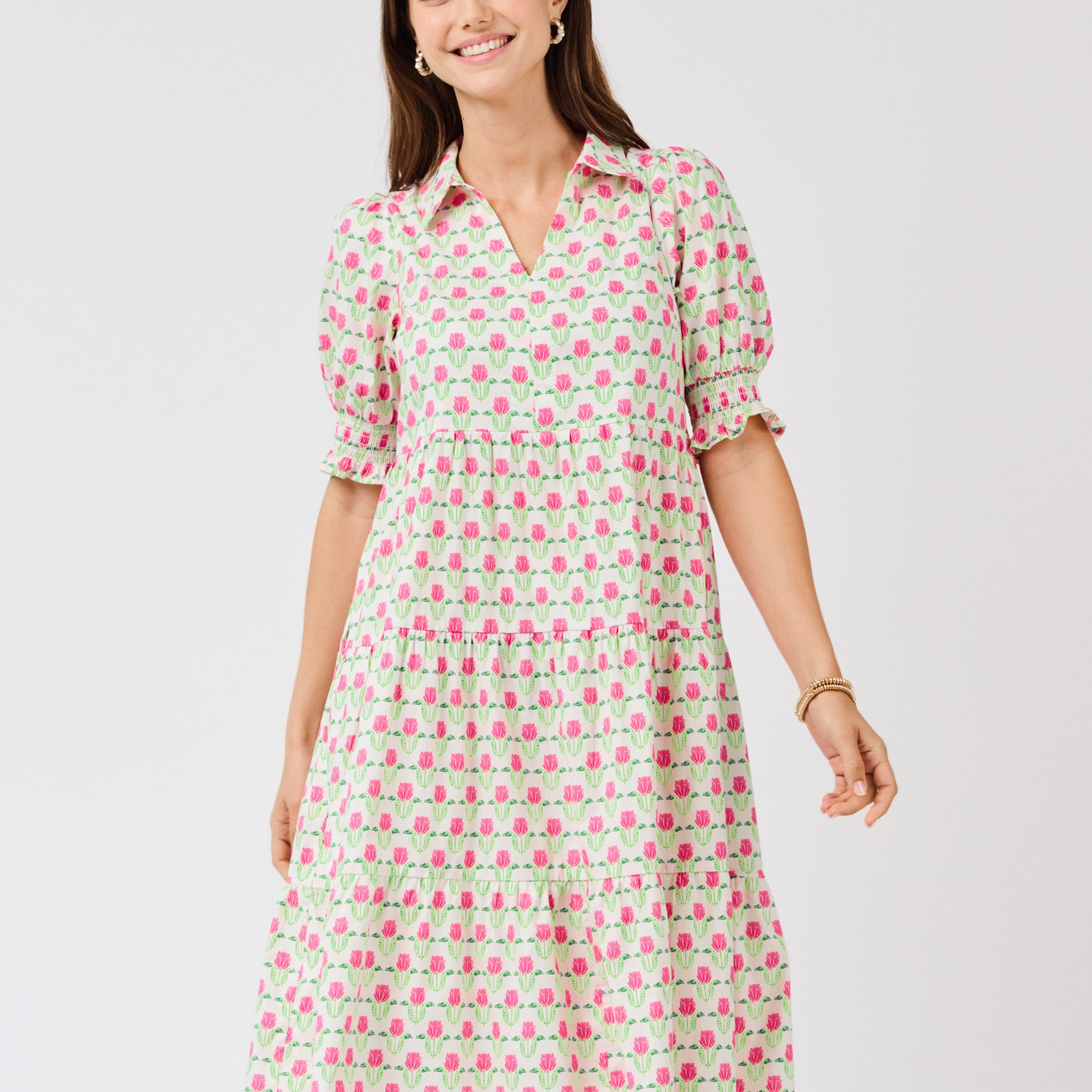 Woman wearing a patterned dress on a white background