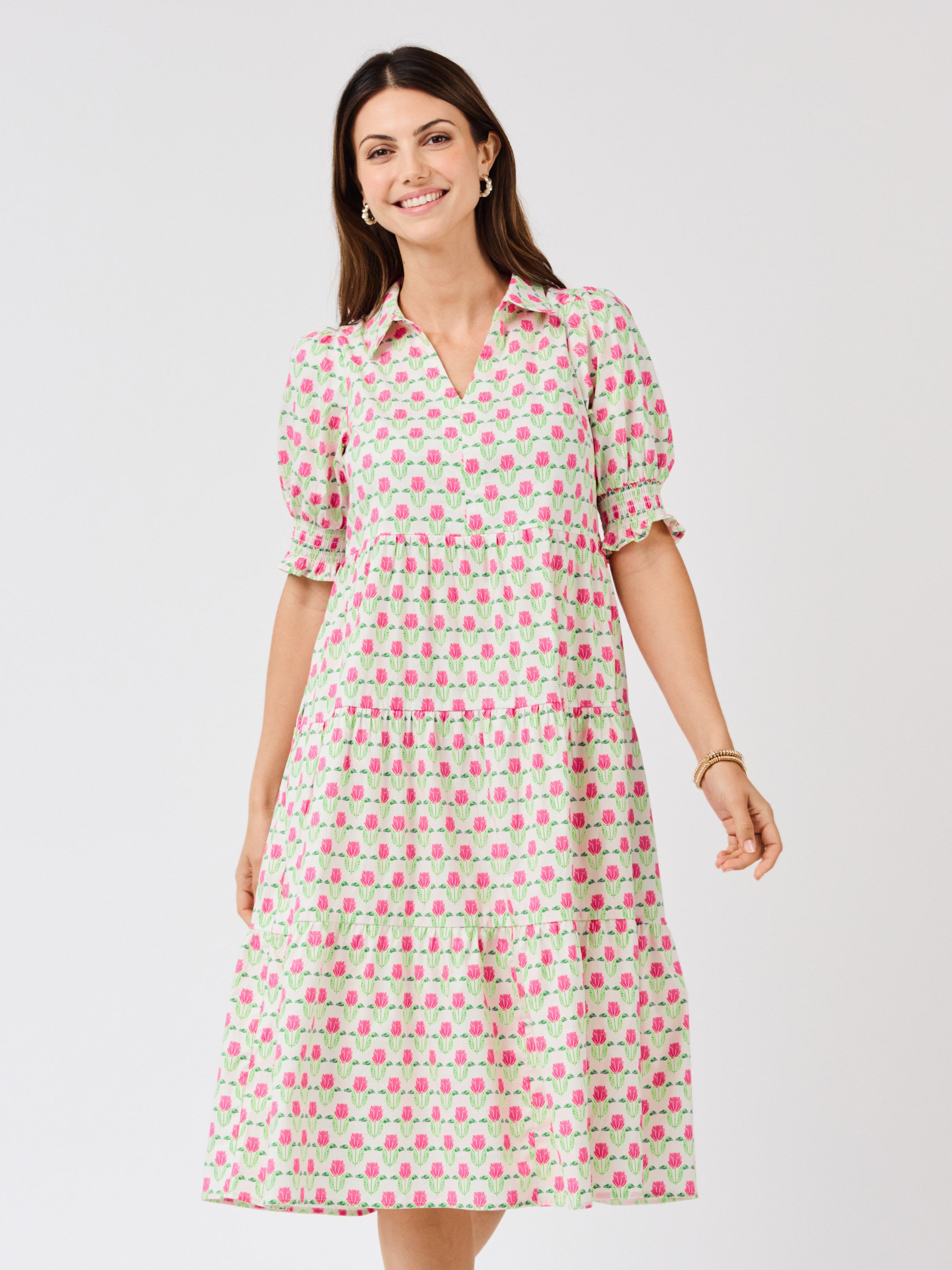 Woman wearing a patterned dress on a white background