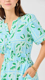 Woman wearing a blue and green patterned dress on a white background