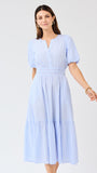 Woman wearing a light blue seersucker midi dress with puff sleeves a white background