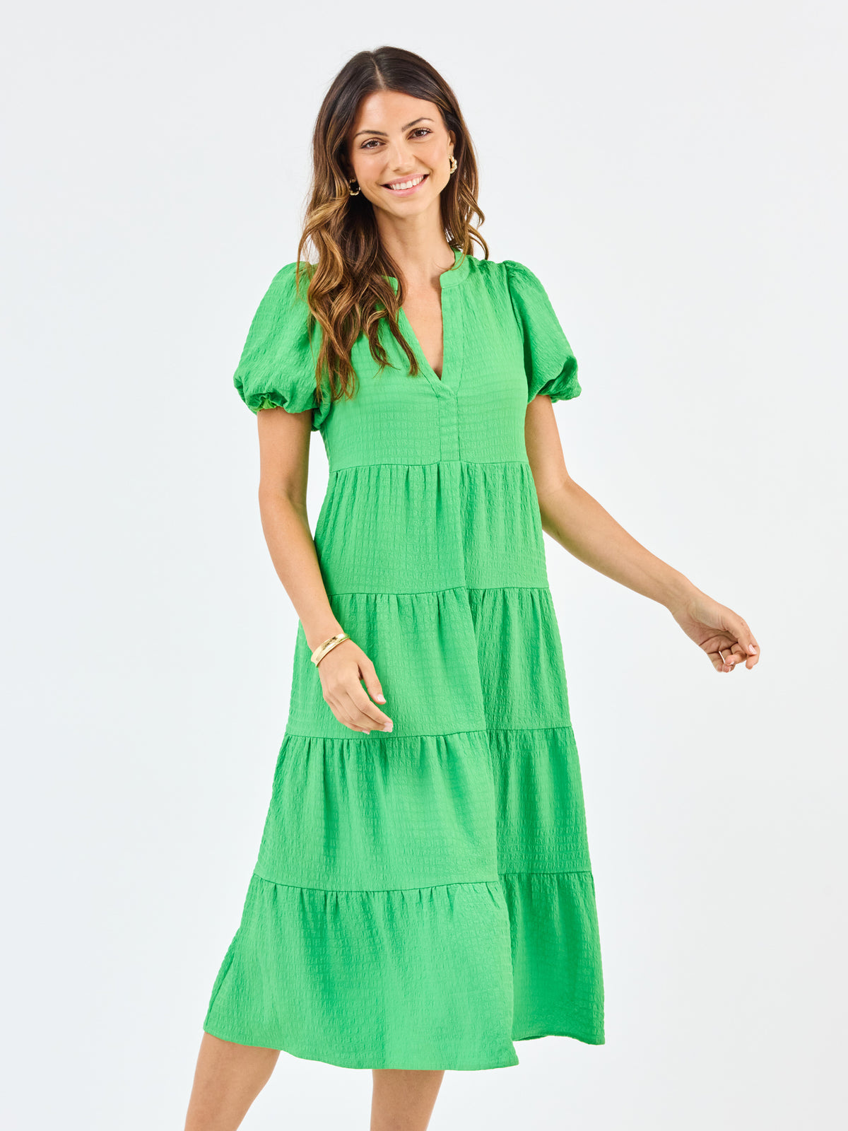 Woman wearing a green dress on a white background
