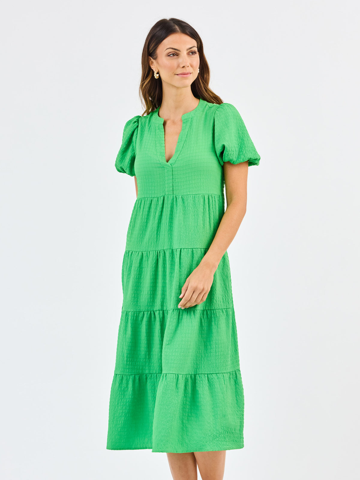 Woman wearing a green dress on a white background