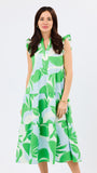 Woman wearing a green and white leaf-patterned dress on a white background