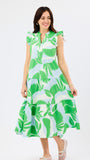 Woman wearing a green and white and blue leaf-patterned dress on a white background
