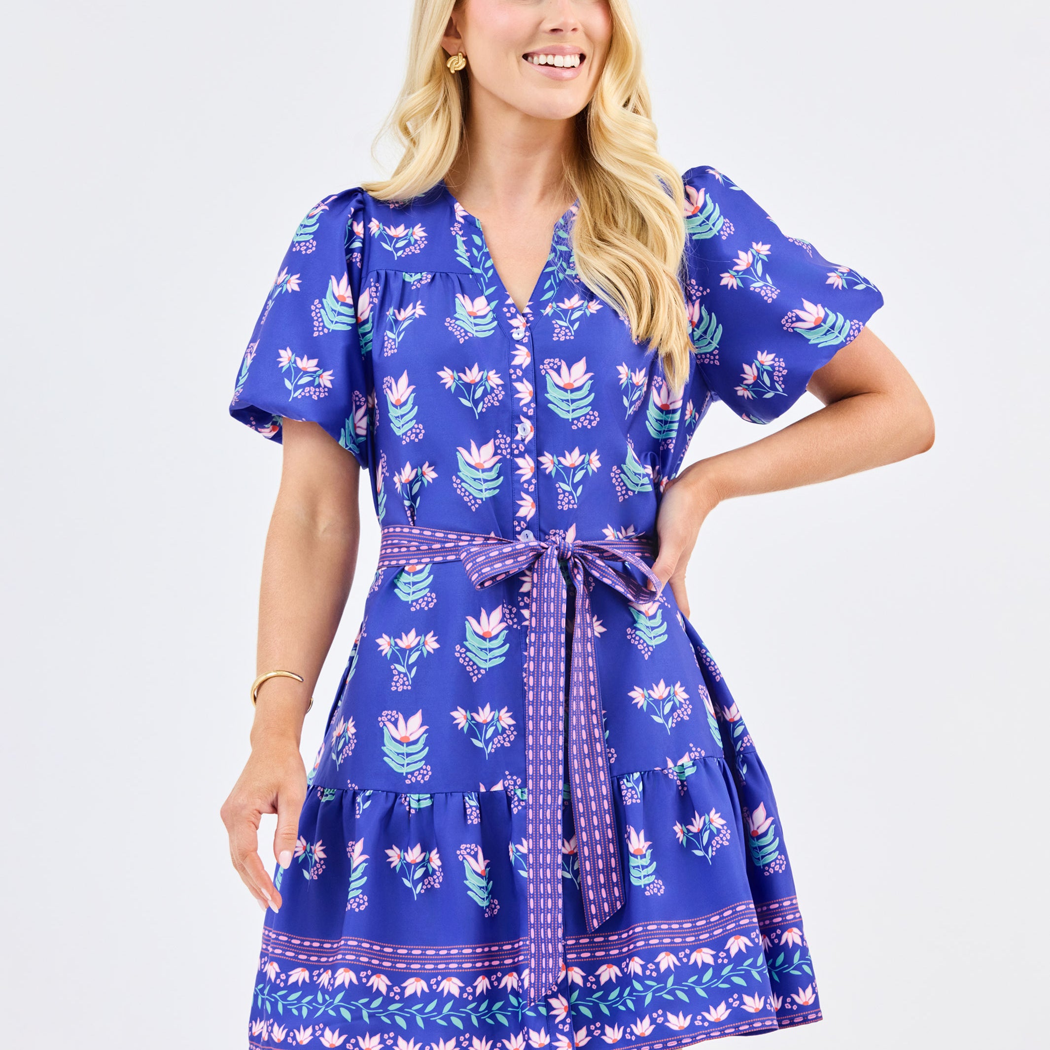 Woman wearing a blue patterned dress on a white background