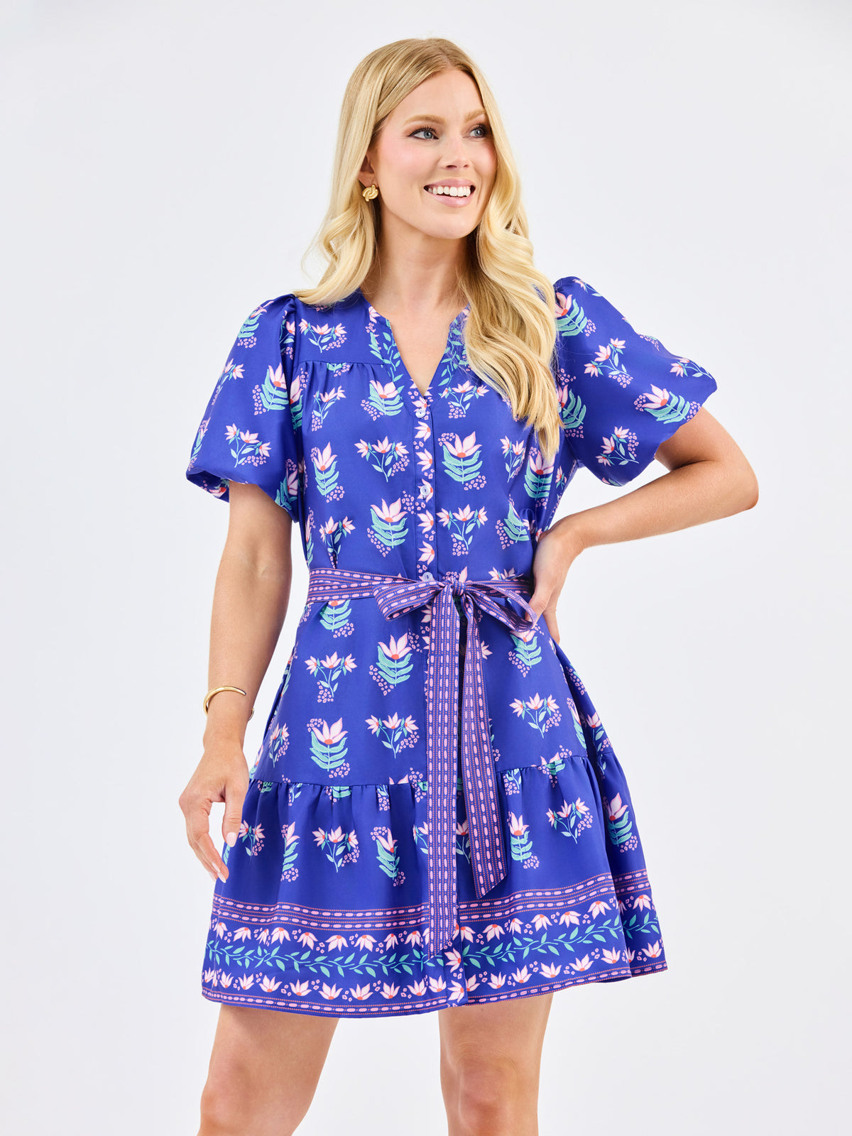 Woman wearing a blue patterned dress on a white background