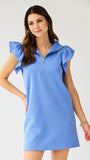 Woman wearing a blue dress with ruffled sleeves on a white background