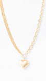 Gold heart-shaped pendant necklace on a white background