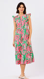Woman wearing a colorful dress with a floral pattern on a white background