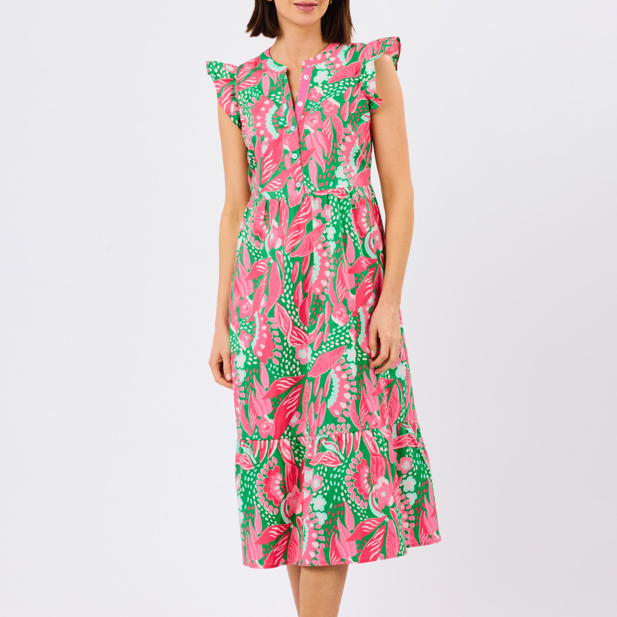 Woman wearing a colorful dress with a floral pattern on a white background