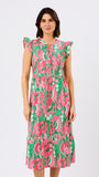 Woman wearing a pink and green floral dress on a white background
