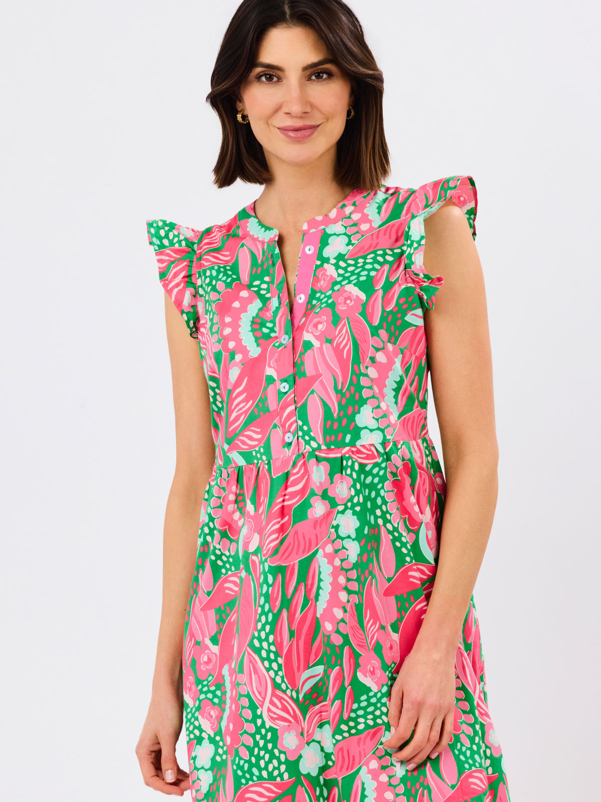 Woman wearing a colorful floral dress on a white background
