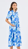Woman wearing a blue floral dress on a white background