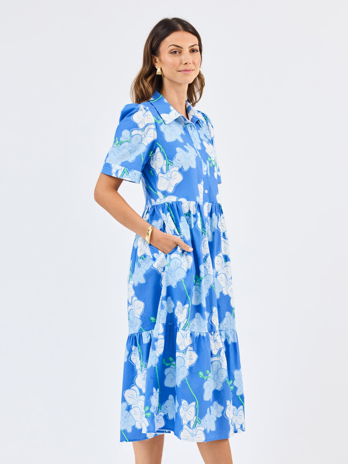 Woman wearing a blue floral dress on a white background