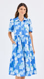 Woman wearing a blue floral dress on a white background