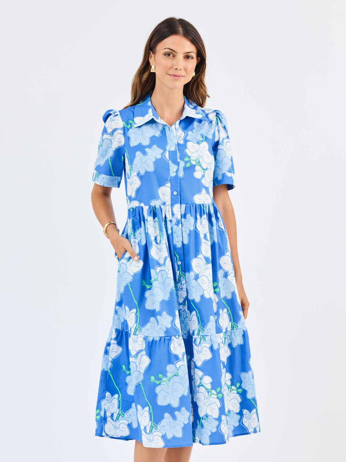 Woman wearing a blue floral dress on a white background