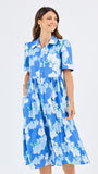 Woman wearing a blue floral dress on a white background