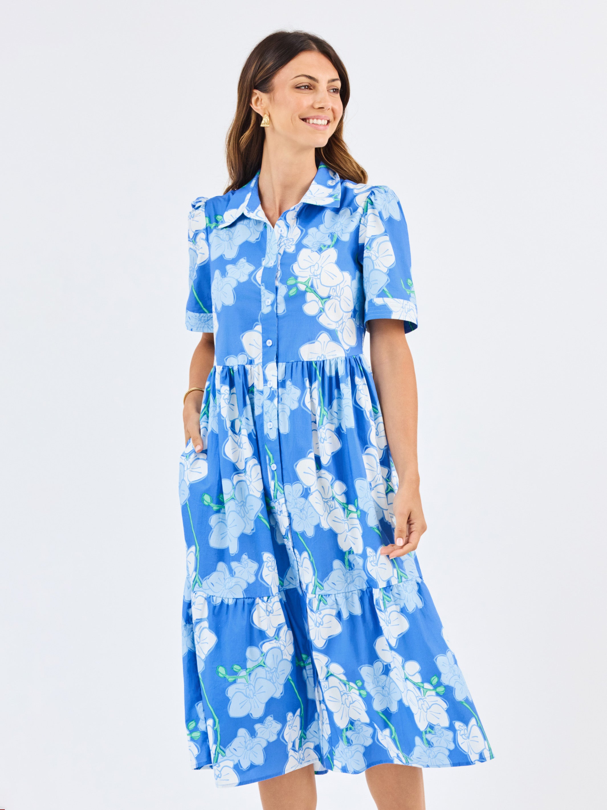 Woman wearing a blue floral dress on a white background