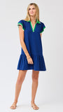 Woman wearing a blue dress with green trim on a white background