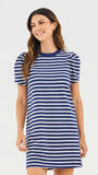 Woman wearing a blue and white striped dress on a light gray background