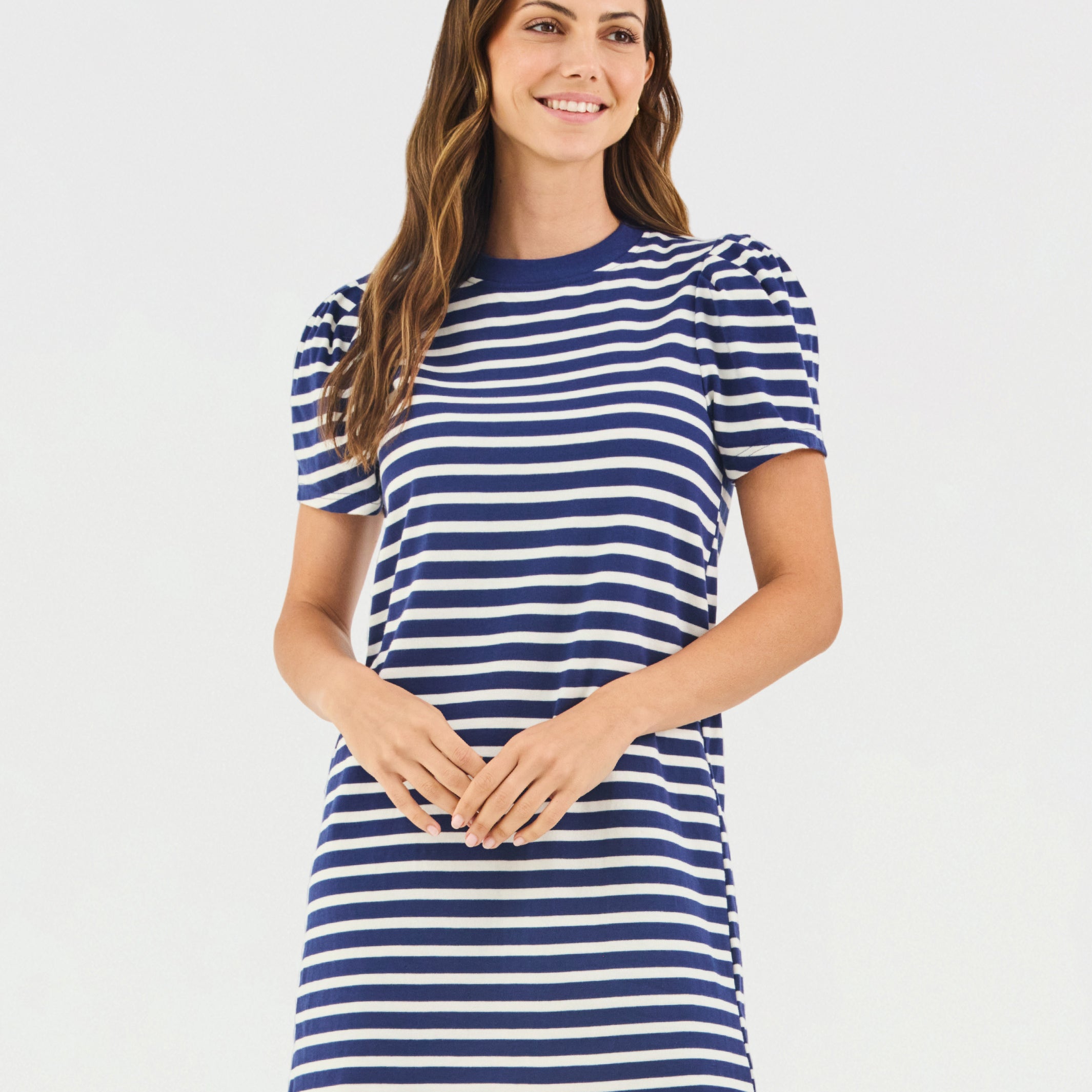Woman wearing a blue and white striped dress on a white background