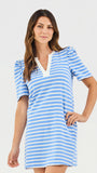 Woman wearing a blue and white striped dress on a light gray background