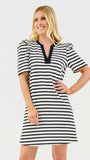 Woman wearing a black and white striped dress on a light gray background