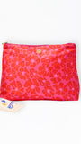 Pink floral pouch with a visible brand logo on a white background