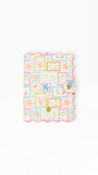 Colorful patterned passport with a decorative clasp on a white background