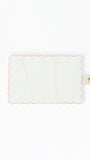 White interior passport cover with pink scalloped edge on a white background