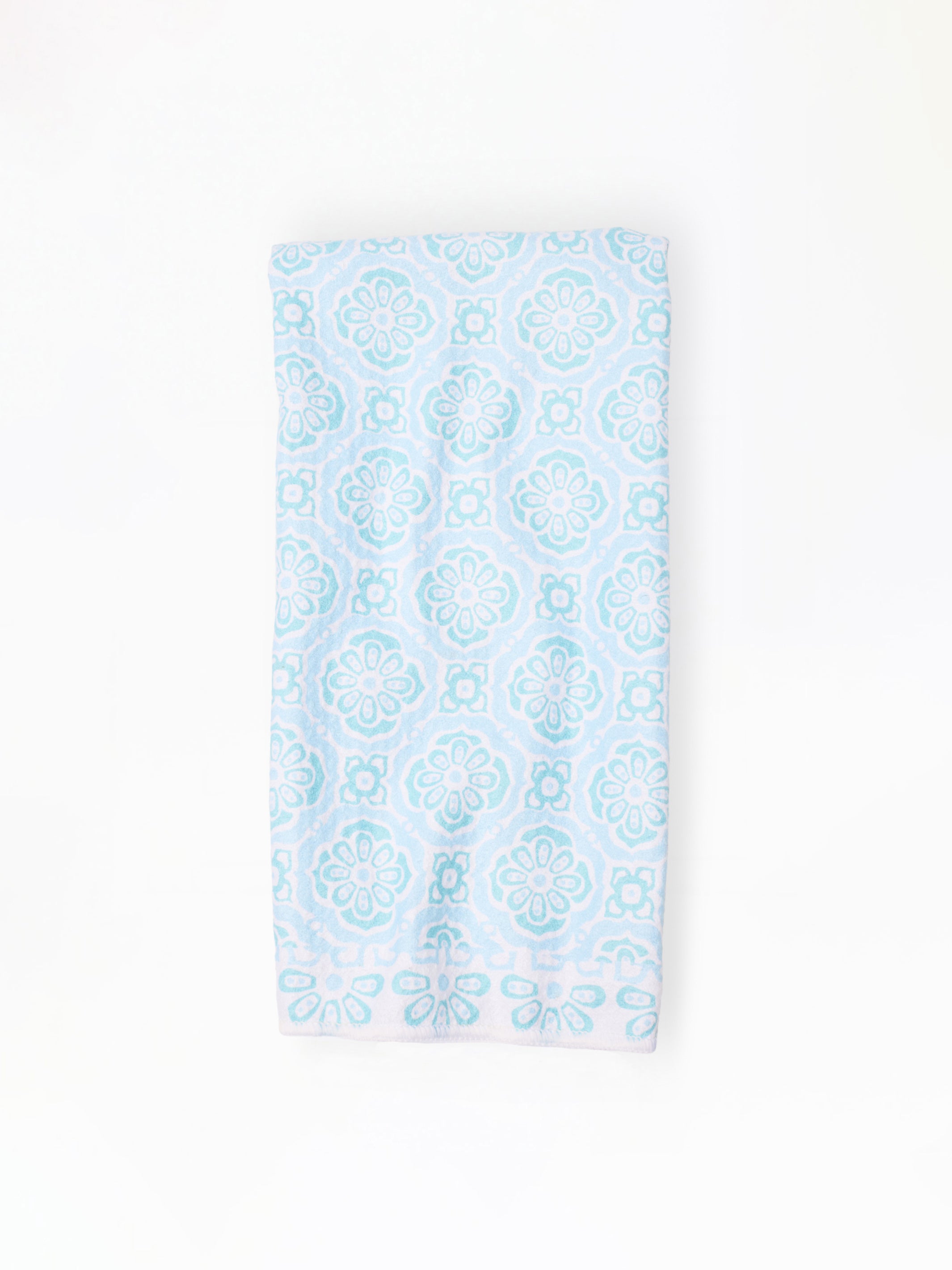 Light blue patterned dish towel on a white background