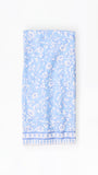 Light blue dish towel with white floral pattern on a white background
