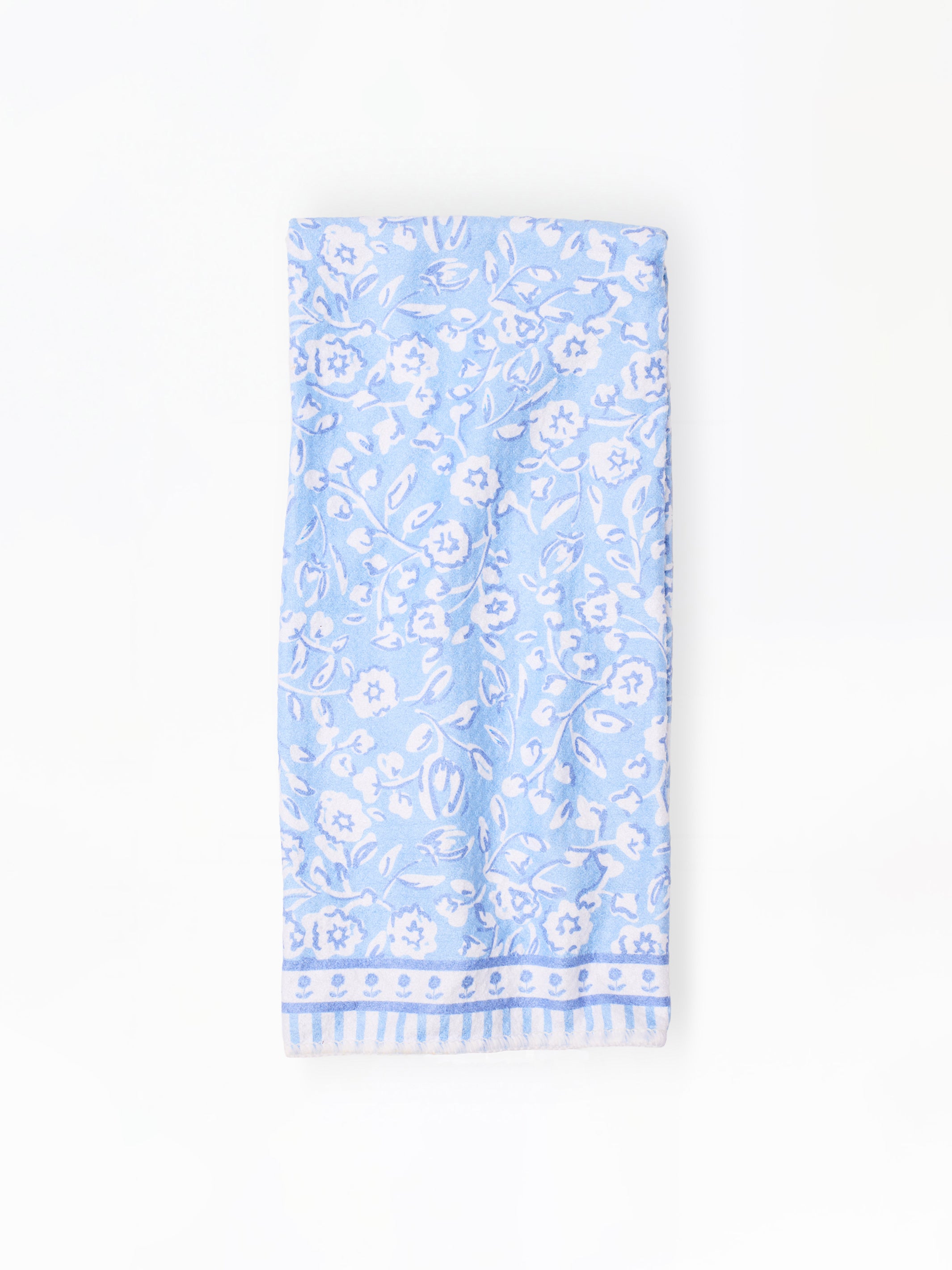 Light blue dish towel with white floral pattern on a white background