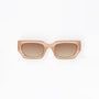 Beige sunglasses with brown gradient lenses on a white background
