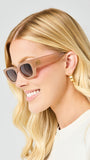 Woman wearing sunglasses with a neutral background