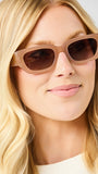 Woman wearing brown sunglasses with a neutral background