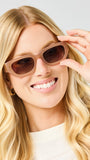 Woman wearing sunglasses with a plain background