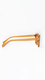Sunglasses with a tan frame on a white background