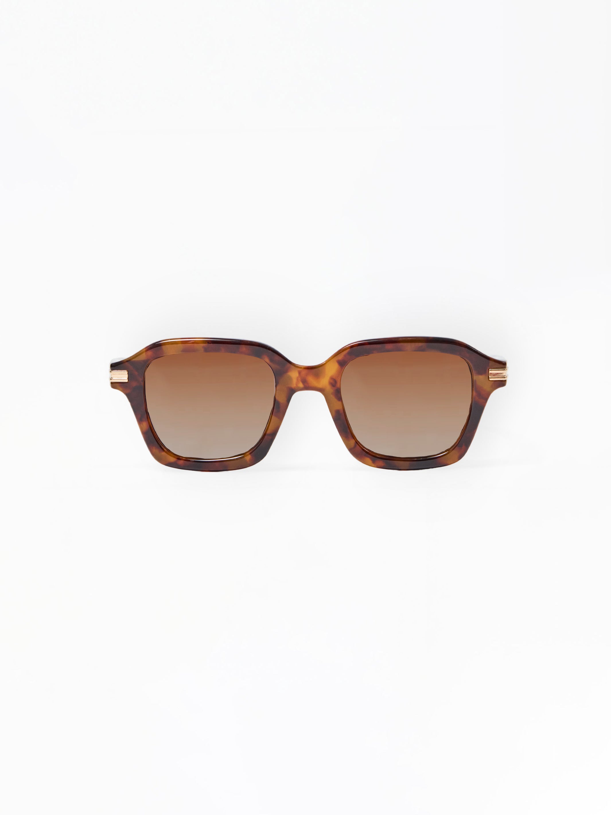 Sunglasses with tortoiseshell frame and brown lenses on a white background