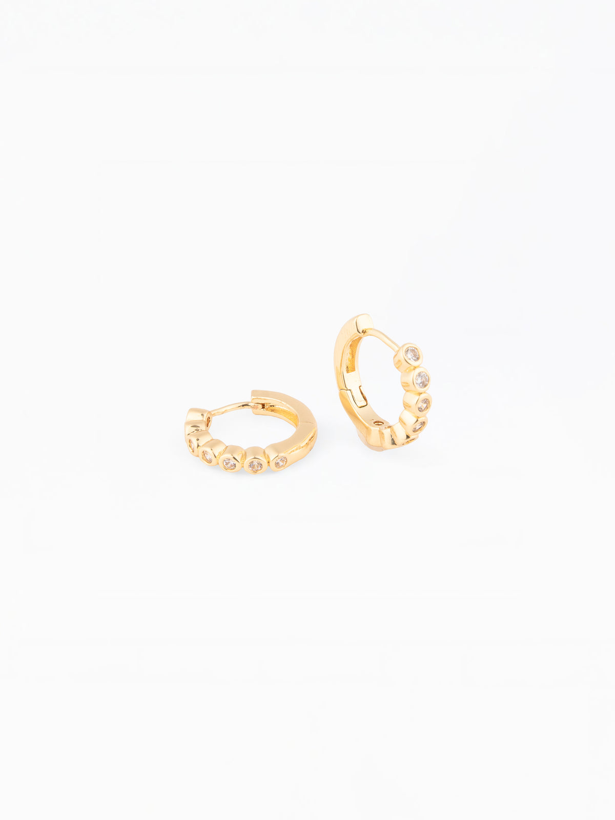 Gold hoop earrings on a white background