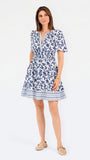 Women with short brown hair wearing a blue printed floral mini dress