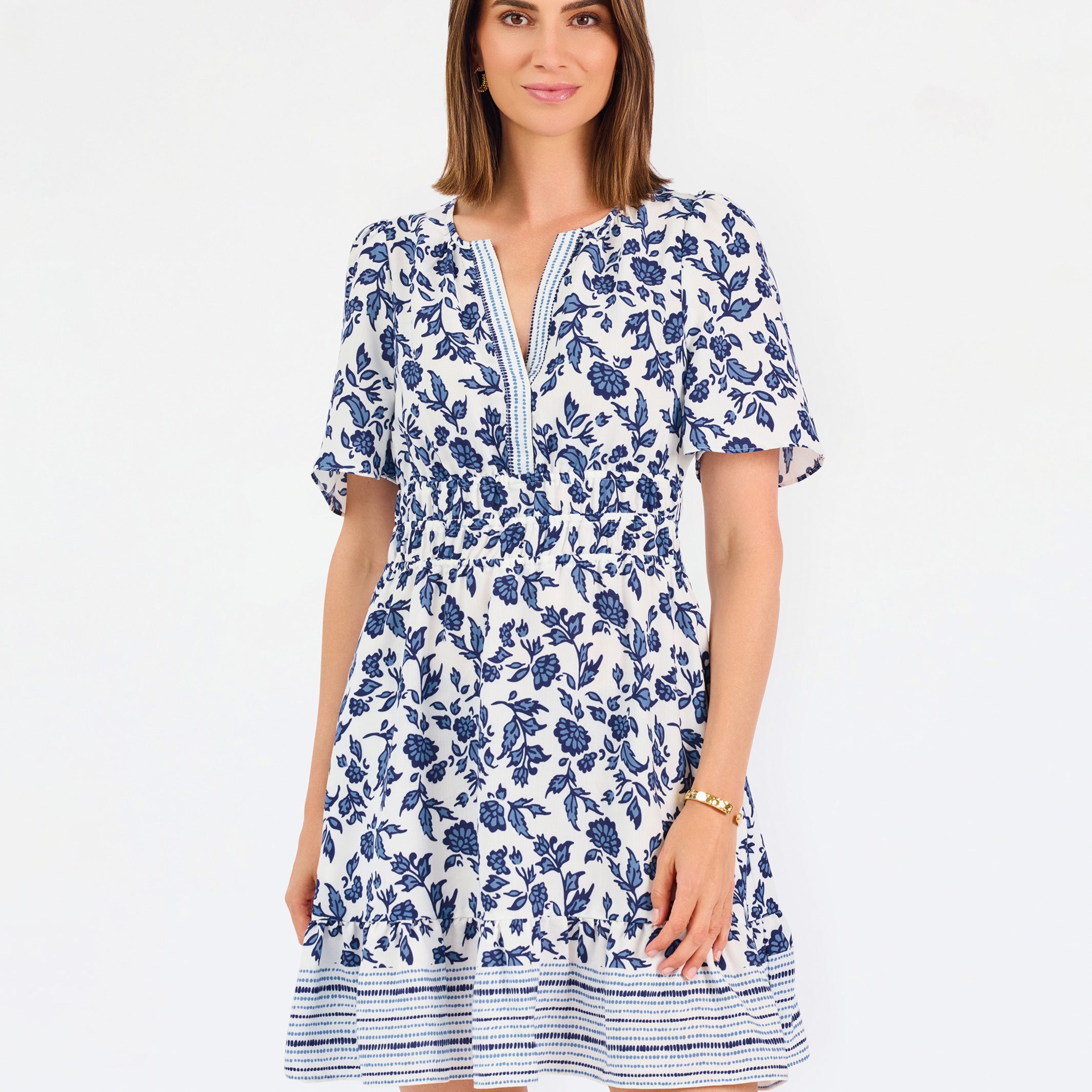Women with short brown hair wearing a blue printed floral mini dress