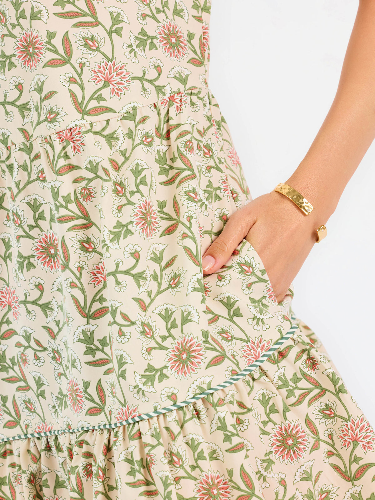 floral green and tan mini dress with puff sleeves and green stripe trim